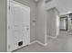 Neutral entryway features light grey walls and tile floors adjacent to a white front door with a dog door at 708 Kibbey St, Las Vegas, NV 89178