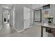 Inviting hallway featuring a large mirror, neutral color palette, and tile flooring leading to bedrooms at 708 Kibbey St, Las Vegas, NV 89178
