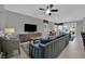 Comfortable living room with TV, ceiling fan, lots of light, and open concept leading to dining area at 708 Kibbey St, Las Vegas, NV 89178