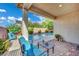 Covered patio features outdoor seating and a view of the pool and desert landscaping at 708 Kibbey St, Las Vegas, NV 89178