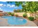 A refreshing backyard pool is surrounded by verdant trees and rock landscaping at 708 Kibbey St, Las Vegas, NV 89178