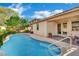 Swimming pool with a baja step and a covered patio that provides shade and outdoor space at 708 Kibbey St, Las Vegas, NV 89178