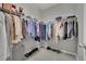 Walk-in closet with wall-mounted wire racks for clothing and shoe storage on neutral flooring at 708 Kibbey St, Las Vegas, NV 89178