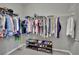 Functional walk-in closet with wall-mounted wire racks for clothing and shoe storage on neutral flooring at 708 Kibbey St, Las Vegas, NV 89178