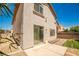 Well-maintained backyard featuring a concrete patio, small grass area, and lush landscaping at 7083 Somera Way, Las Vegas, NV 89113