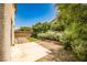 Private backyard featuring mature trees, manicured hedges, and low-maintenance landscaping at 7083 Somera Way, Las Vegas, NV 89113