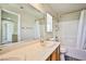 Bathroom features a double sink vanity, shower-tub, and tile backsplash at 7083 Somera Way, Las Vegas, NV 89113