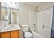 Bright bathroom features a tub with shower, single sink vanity, and neutral finishes at 7083 Somera Way, Las Vegas, NV 89113