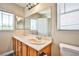 Bathroom features a dual sink vanity with a large mirror and a window at 7083 Somera Way, Las Vegas, NV 89113
