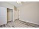 Bright bedroom features a ceiling fan, closet, and stylish gray wood flooring at 7083 Somera Way, Las Vegas, NV 89113