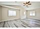 Vaulted bedroom with natural light, gray wood floors, and modern ceiling fan at 7083 Somera Way, Las Vegas, NV 89113