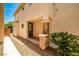 Covered entryway with decorative stone columns, dark front door, and tidy landscaping at 7083 Somera Way, Las Vegas, NV 89113