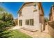 Two-story home with well-maintained backyard, including a patio and lush landscaping at 7083 Somera Way, Las Vegas, NV 89113