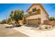 Two-story home featuring a two car garage, neutral color palette, and stone accents on exterior at 7083 Somera Way, Las Vegas, NV 89113