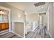 Upstairs hallway features neutral walls, gray wood floors, and access to rooms at 7083 Somera Way, Las Vegas, NV 89113