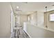 Bright hallway with gray wood floors and neutral paint offers seamless transition at 7083 Somera Way, Las Vegas, NV 89113
