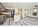 Open floor plan with kitchen island, stainless appliances, and cozy fireplace nearby at 7083 Somera Way, Las Vegas, NV 89113