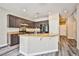 Well-lit kitchen area featuring granite countertops, dark wood cabinets and modern appliances at 7083 Somera Way, Las Vegas, NV 89113