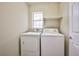Laundry room features modern washer and dryer with natural light from window at 7083 Somera Way, Las Vegas, NV 89113