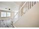 View of the living room with light gray wood floors, a stairway, and many windows at 7083 Somera Way, Las Vegas, NV 89113