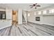 Bright living space featuring sleek flooring, modern kitchen, and inviting fireplace at 7083 Somera Way, Las Vegas, NV 89113