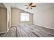 This spacious main bedroom includes a ceiling fan, gray flooring, and lots of natural light at 7083 Somera Way, Las Vegas, NV 89113