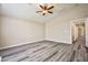 This spacious main bedroom boasts gray vinyl floors, a ceiling fan, and is freshly painted at 7083 Somera Way, Las Vegas, NV 89113