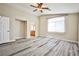 This spacious main bedroom boasts lots of natural light, gray flooring, and en suite bathroom at 7083 Somera Way, Las Vegas, NV 89113