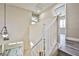 White staircase with gray wood floors connects the home's different levels at 7083 Somera Way, Las Vegas, NV 89113