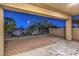 Covered back patio with a zebra rug, desert landscaping, and views of neighboring houses at 722 Descartes Ave, Henderson, NV 89002