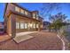 Expansive backyard with desert landscaping, a covered patio, and views of the Nevada landscape at 722 Descartes Ave, Henderson, NV 89002
