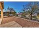 Backyard with desert landscaping, a view of surrounding homes, and dusk sky at 722 Descartes Ave, Henderson, NV 89002