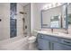 Stylish bathroom with a tub and shower combination, framed mirror, and attractive tile accents at 722 Descartes Ave, Henderson, NV 89002