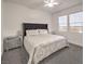 Serene bedroom featuring a plush headboard, mirrored nightstands, and large windows with blinds at 722 Descartes Ave, Henderson, NV 89002