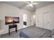 Well-lit bedroom with neutral carpet, ceiling fan, and access to an attached bathroom at 722 Descartes Ave, Henderson, NV 89002
