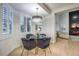 Charming dining area features a glass table, shutters, a modern chandelier, and comfortable seating at 722 Descartes Ave, Henderson, NV 89002