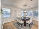 Bright dining area featuring wood floors and a modern chandelier at 722 Descartes Ave, Henderson, NV 89002