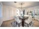 Bright dining room features a modern chandelier, a gray rug and seats six comfortably at 722 Descartes Ave, Henderson, NV 89002