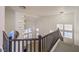 Grand foyer featuring high ceilings, modern chandeliers, and an elegant staircase with dark wood banister at 722 Descartes Ave, Henderson, NV 89002