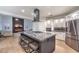 Gourmet kitchen with a large island, stainless appliances, granite countertops, and a range hood at 722 Descartes Ave, Henderson, NV 89002