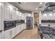 Stylish kitchen features stainless appliances, custom cabinets, granite countertops, and seamless access to dining at 722 Descartes Ave, Henderson, NV 89002