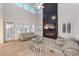 Spacious living room features a fireplace, entertainment center, and tall windows for natural light at 722 Descartes Ave, Henderson, NV 89002