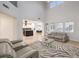 Open-concept living room features a glass coffee table and seamlessly connects to the kitchen at 722 Descartes Ave, Henderson, NV 89002