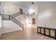 Bright open living space features high ceilings, wood floors, and wrought iron staircase at 722 Descartes Ave, Henderson, NV 89002