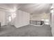 Open loft area with carpet, modern lighting, and views of the floor below through a dark wood banister at 722 Descartes Ave, Henderson, NV 89002