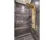 Custom shower with a gold rainfall shower head, wall jets, integrated bench, and dark marble-style tile at 722 Descartes Ave, Henderson, NV 89002