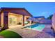 Inviting backyard with a shimmering pool, ample patio space, and artificial turf at 7235 Summer Air Ave, Las Vegas, NV 89179