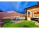 Lush backyard showcasing artificial turf, a cozy seating area, and a refreshing pool at 7235 Summer Air Ave, Las Vegas, NV 89179