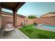 Cozy backyard patio with artificial grass and a refreshing pool, perfect for enjoying outdoor relaxation and leisure at 7235 Summer Air Ave, Las Vegas, NV 89179