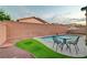 Charming backyard with artificial grass, comfortable seating, and a refreshing pool for outdoor relaxation and fun at 7235 Summer Air Ave, Las Vegas, NV 89179